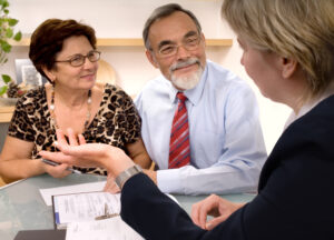 Mature couple talking to financial planner